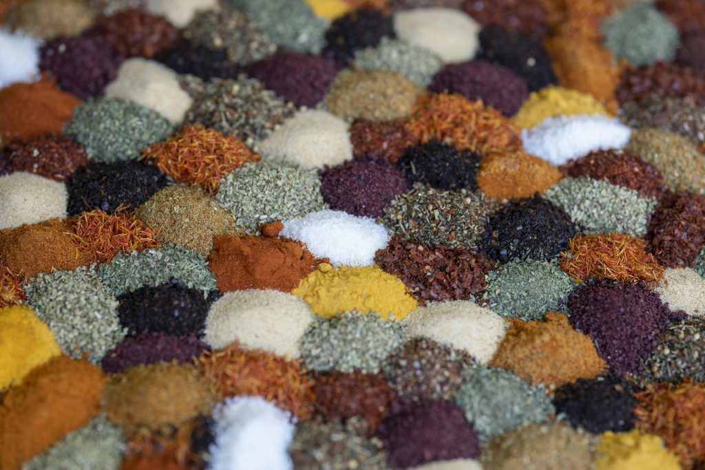 Assorted dried herbs and spices in small bowls